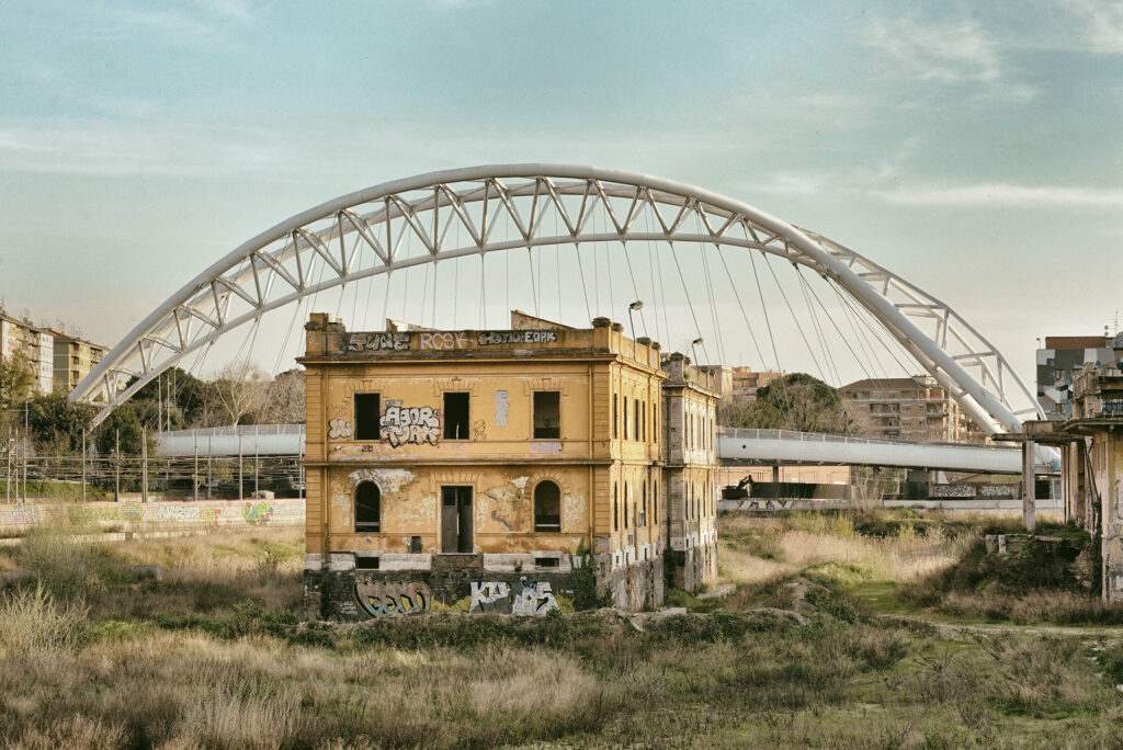 abandoned yellow house under a bridge