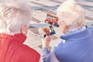 gray-haired ladies looking at photos