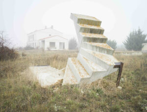 forgotten white concrete staircase in the field with fog